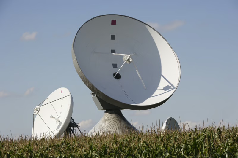 Satellite communication dishes in a rural landscape supporting connectivity and digital access in underserved areas.