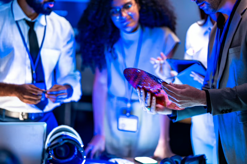 Diverse team of space technology professionals collaborating with advanced aerospace equipment.